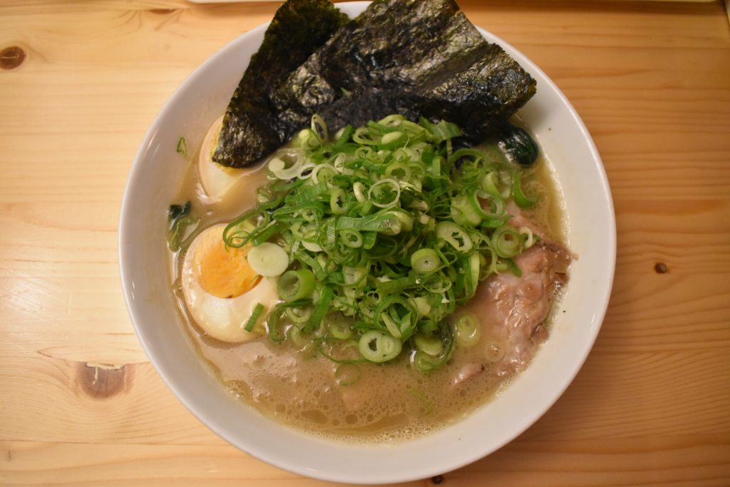 Yokohama-style Iekei ramen with thick soy tonkotsu broth and toppings like chashu and spinach at Yokohama Ramen Saito in Schiedam