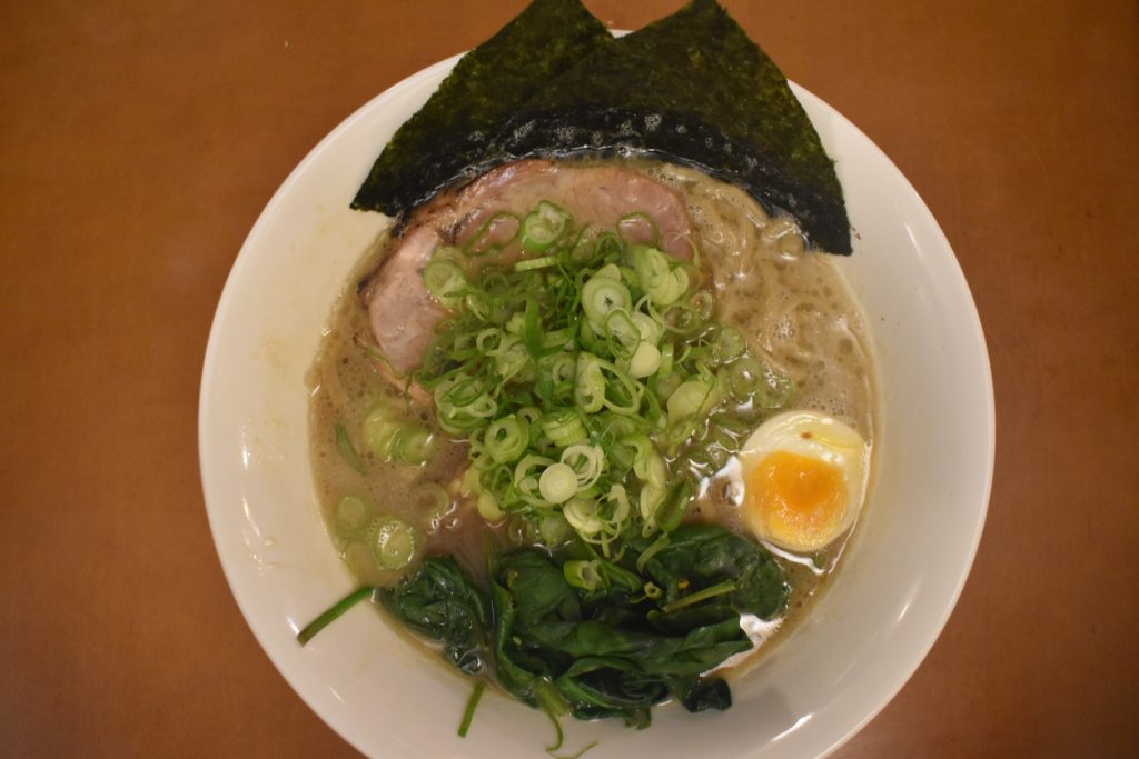 Yokohama-style Iekei ramen with thick soy tonkotsu broth and toppings like chashu and spinach at Yokohama Ramen Saito in Schiedam