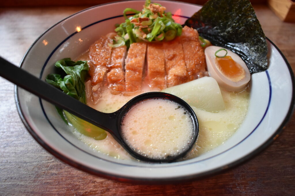 Noukou Chicken Ramen at Takumi De Pijp — creamy white broth topped with chicken chashu and green onions