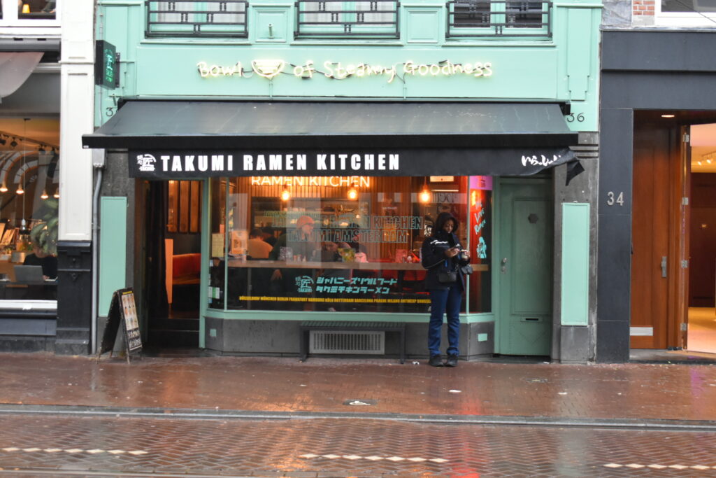 Exterior view of Takumi De Pijp in Amsterdam, a popular ramen spot often crowded even outside lunchtime