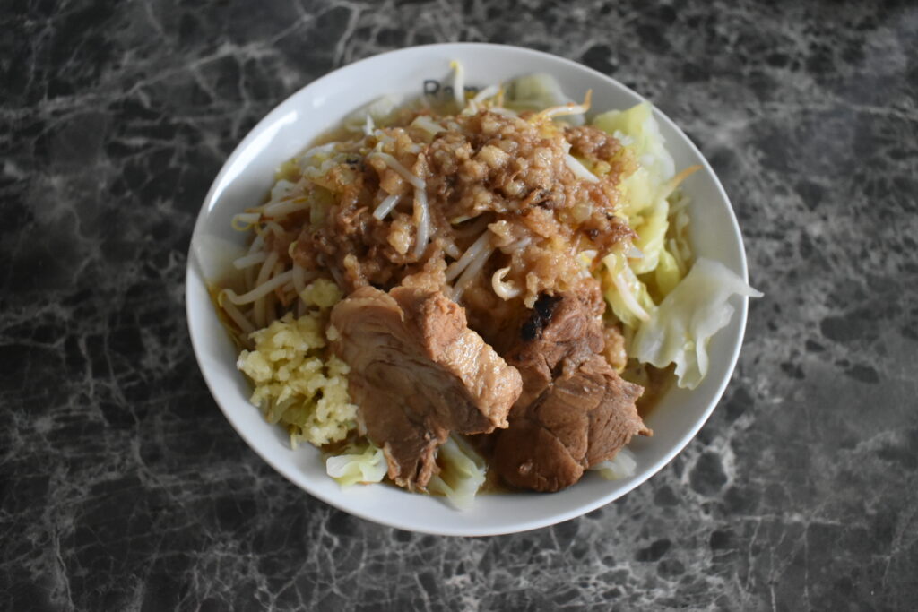 Jiro-style ramen from Ramen Nikkou with thick noodles, pork chashu, bean sprouts, cabbage, and garlic