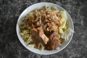 Jiro-style ramen from Ramen Nikkou with thick noodles, pork chashu, bean sprouts, cabbage, and garlic