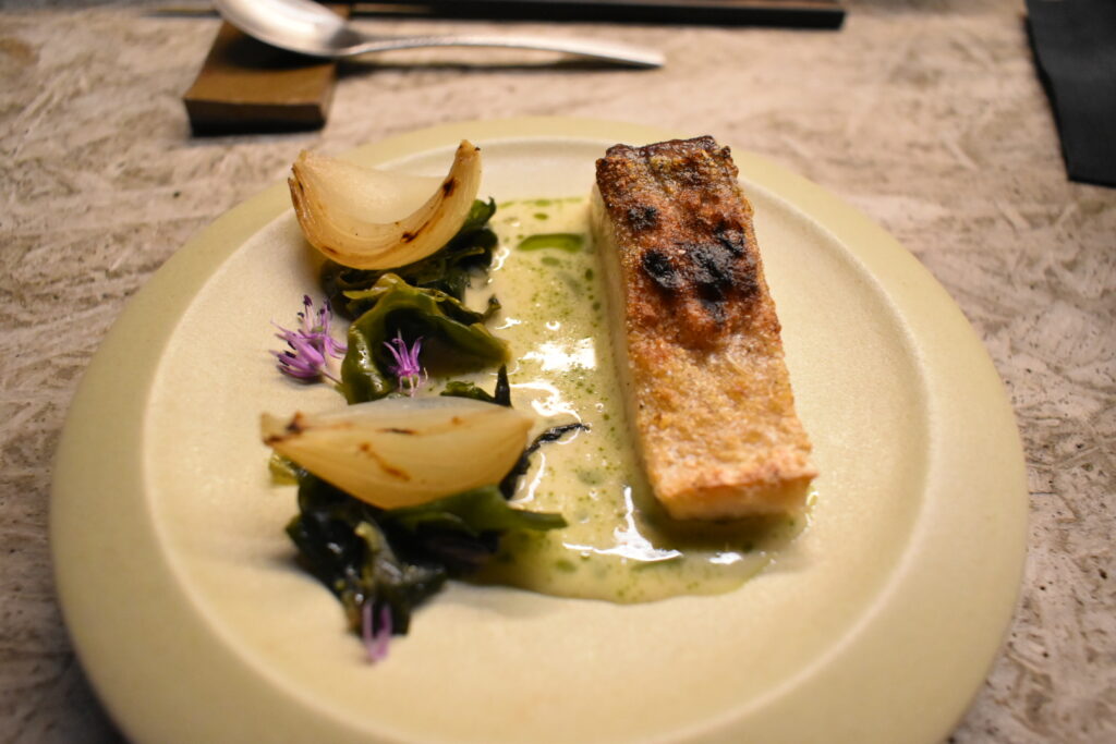 Hiramasa yellowtail with crispy skin, charred onion and herb sauce at Fuku Ramen Amsterdam