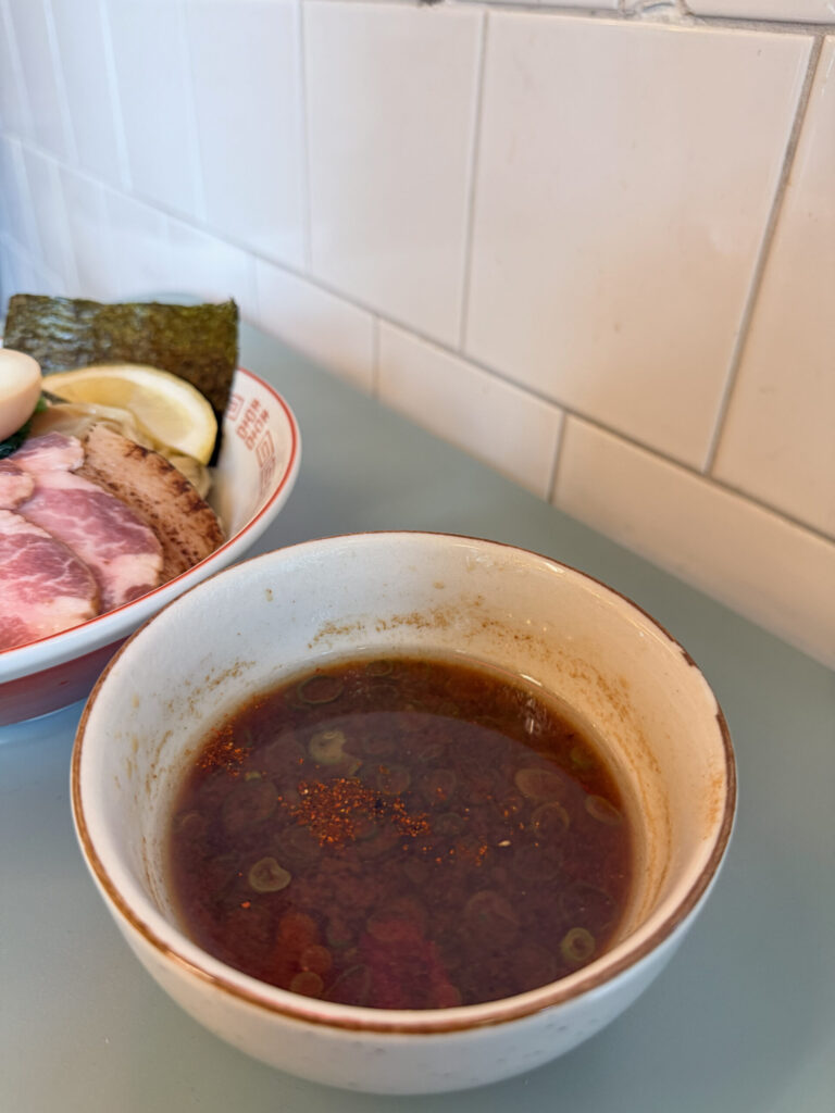 Shoyu tsuyu dipping broth with shichimi togarashi at Smaak Ramen Amsterdam